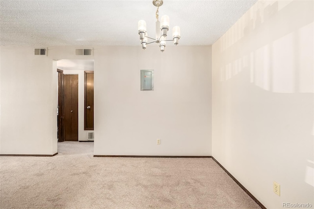 unfurnished room with light colored carpet, a notable chandelier, and a textured ceiling