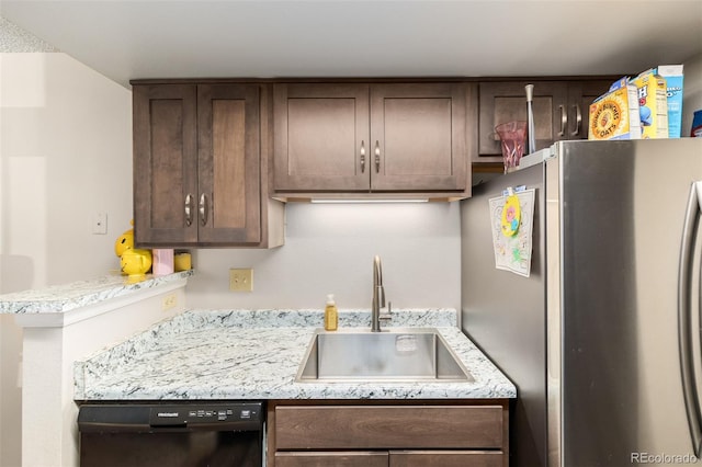 kitchen with dishwasher, stainless steel refrigerator, sink, and dark brown cabinets