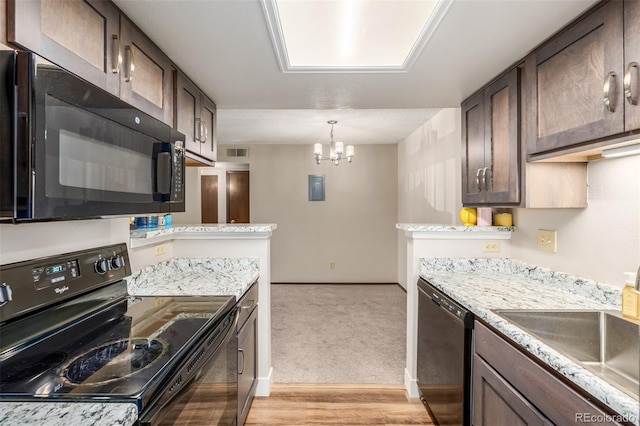 kitchen with dark brown cabinets, light colored carpet, black appliances, and decorative light fixtures