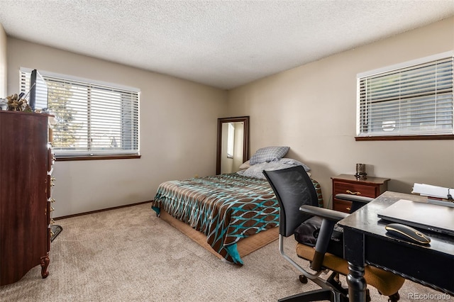 carpeted bedroom featuring a textured ceiling