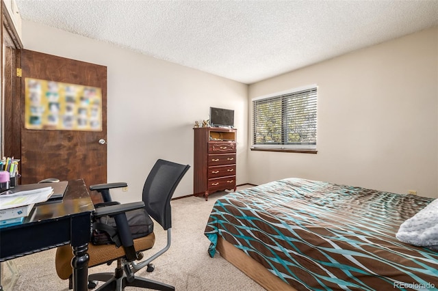 bedroom with light colored carpet and a textured ceiling