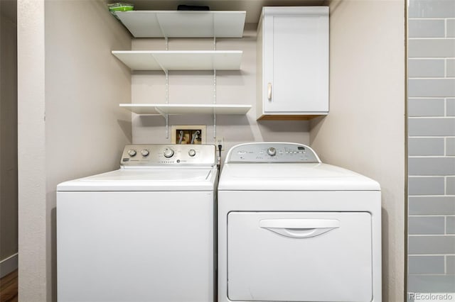 laundry area featuring separate washer and dryer, cabinets, and hookup for a washing machine