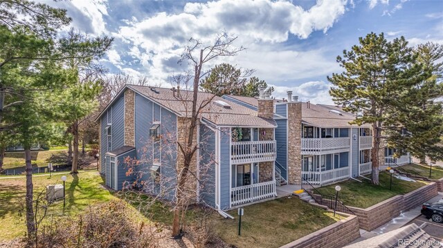 exterior space with a balcony and a yard