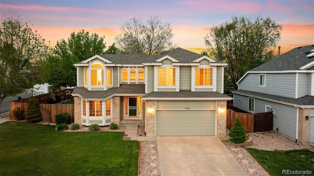 3371 Bexley Dr, Colorado Springs, CO 80922 - view of front facade with brick siding, concrete driveway, a garage, and roof with shingles