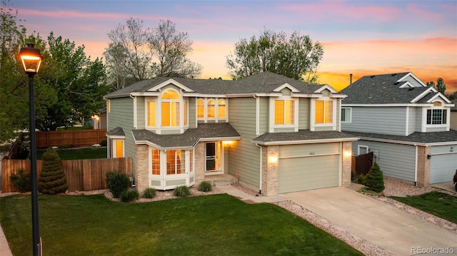 3371 Bexley Dr, Colorado Springs, CO 80922 - view of front of property featuring brick siding, concrete driveway, an attached garage, and a shingled roof