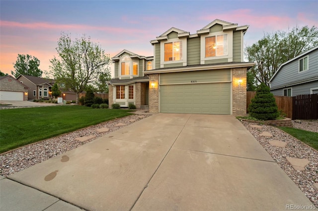 3371 Bexley Dr, Colorado Springs, CO 80922 - traditional-style house with brick siding, an attached garage, and concrete driveway