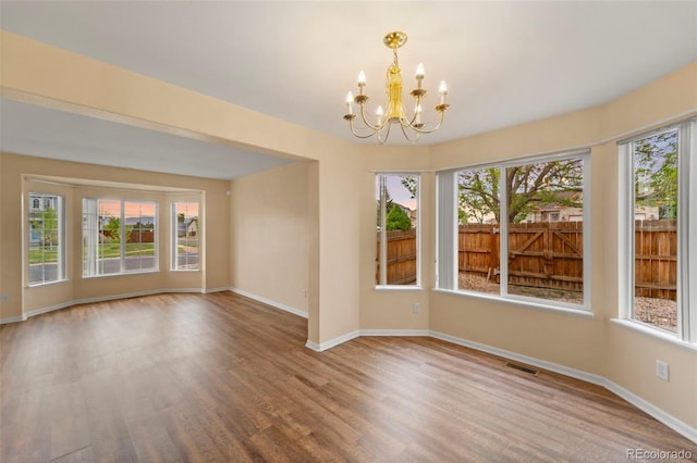 3371 Bexley Dr, Colorado Springs, CO 80922 - unfurnished room featuring a chandelier, healthy amount of natural light, wood finished floors, and baseboards