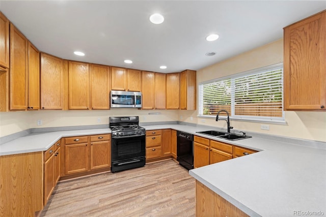 3371 Bexley Dr, Colorado Springs, CO 80922 - kitchen featuring black appliances, a sink, light wood-style floors, light countertops, and recessed lighting