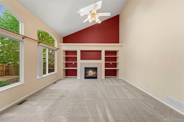 3371 Bexley Dr, Colorado Springs, CO 80922 - unfurnished living room with high vaulted ceiling, carpet flooring, baseboards, a fireplace, and built in features