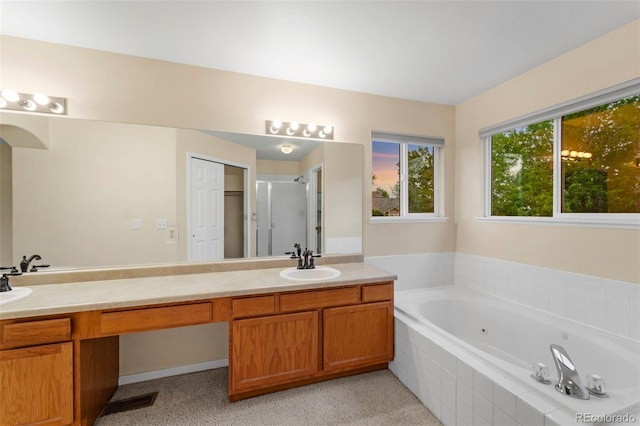 3371 Bexley Dr, Colorado Springs, CO 80922 - bathroom featuring a tub with jets, a shower stall, and double vanity