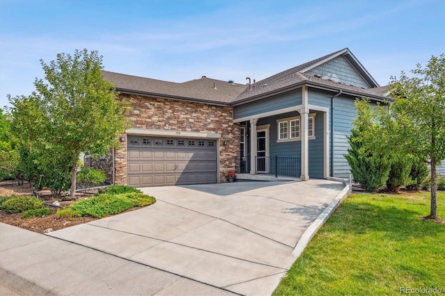 view of front of home with a garage and a front lawn