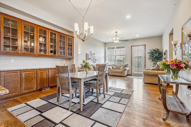 dining room with a chandelier and wood-type flooring