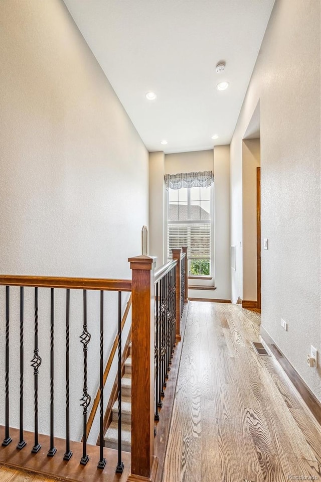 corridor with light hardwood / wood-style floors