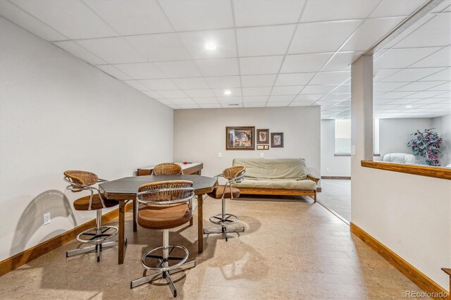 dining space featuring a drop ceiling