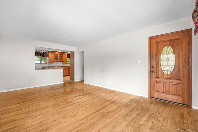 7742 W Florida Dr, Lakewood, CO 80232 - foyer entrance featuring light wood finished floors