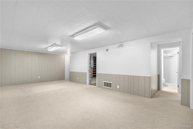 7742 W Florida Dr, Lakewood, CO 80232 - carpeted spare room featuring a wainscoted wall and wooden walls