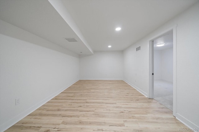 unfurnished room with recessed lighting, light wood-style flooring, and baseboards