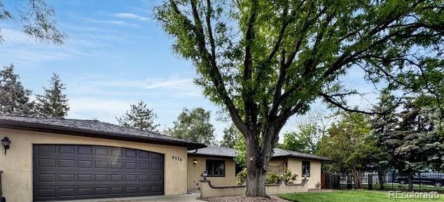 6376 Lamar Pl, Arvada, CO 80003 - ranch-style home with stucco siding, a garage, and concrete driveway