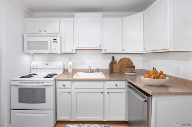 kitchen featuring white cabinetry, sink, crown molding, and white appliances