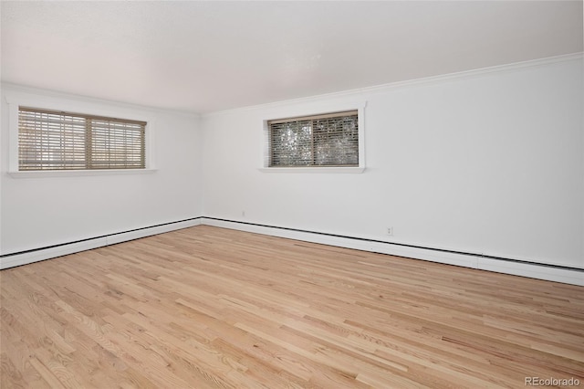 empty room featuring crown molding and light hardwood / wood-style flooring