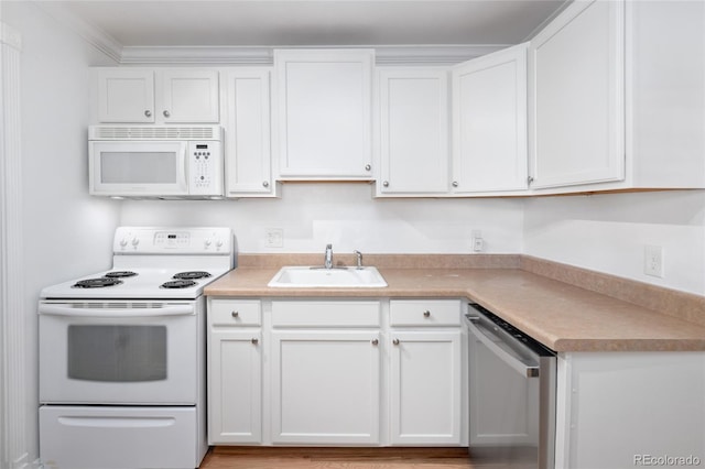 kitchen featuring white cabinets, crown molding, white appliances, and sink