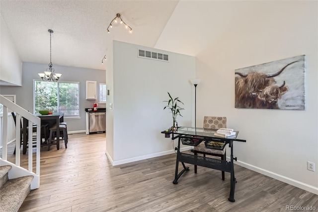 3734 Licorice Trl, Castle Rock, CO 80109 - dining area with lofted ceiling, stairs, wood finished floors, and a chandelier