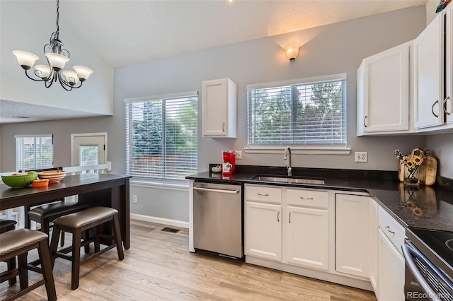 3734 Licorice Trl, Castle Rock, CO 80109 - kitchen with stainless steel dishwasher, lofted ceiling, white cabinets, a chandelier, and dark countertops