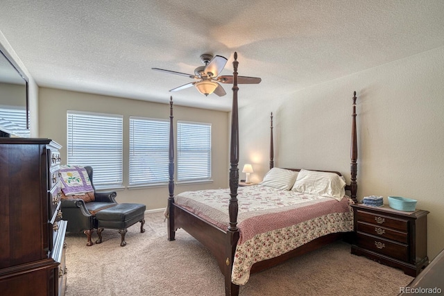 carpeted bedroom with ceiling fan and a textured ceiling