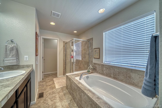 bathroom featuring vanity and plus walk in shower