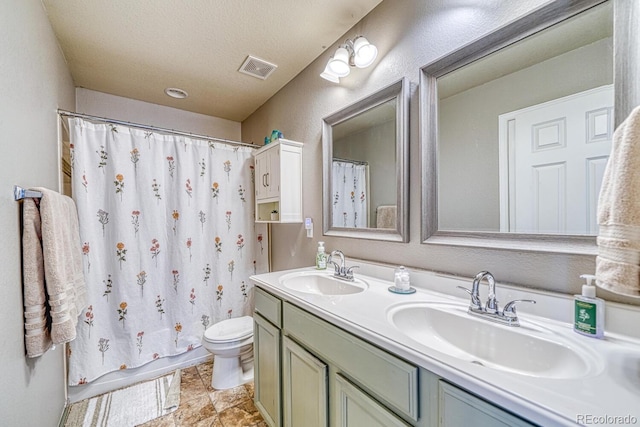 full bathroom featuring shower / bathtub combination with curtain, vanity, a textured ceiling, and toilet