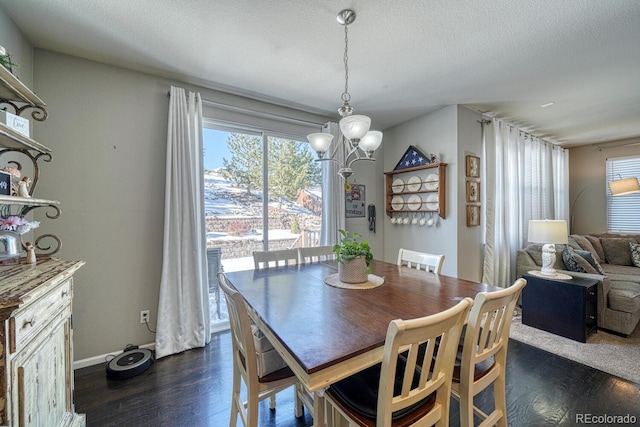 dining room with a notable chandelier, dark hardwood / wood-style flooring, and a textured ceiling