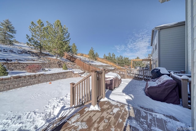 snow covered deck featuring a grill