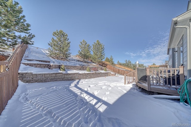 snow covered patio with a deck