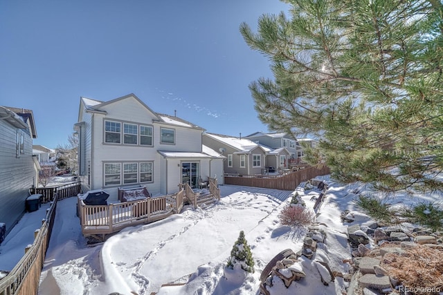 view of snow covered back of property