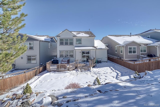 view of snow covered back of property