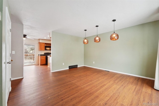 empty room with hardwood / wood-style flooring and ceiling fan