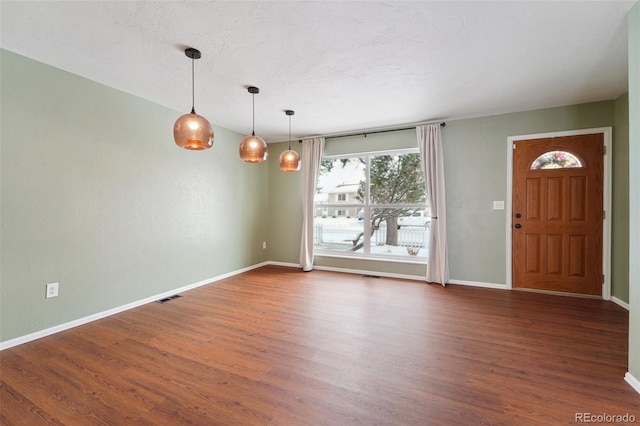 interior space with dark hardwood / wood-style floors and a textured ceiling