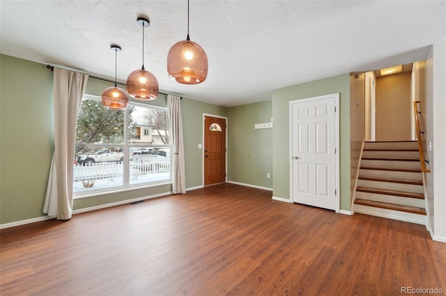 interior space featuring dark wood-type flooring and a textured ceiling