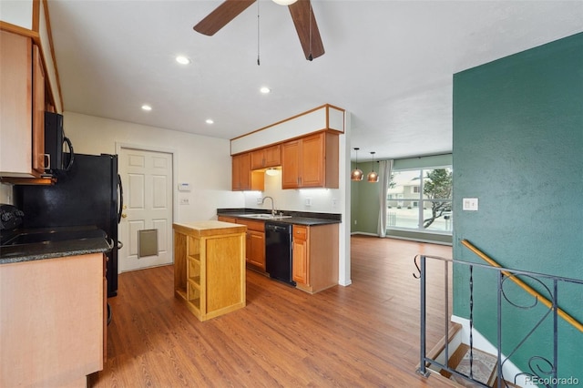 kitchen with sink, a center island, light hardwood / wood-style flooring, ceiling fan, and black appliances