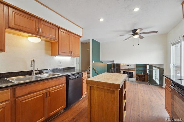 kitchen featuring butcher block counters, sink, wood-type flooring, black dishwasher, and a kitchen island