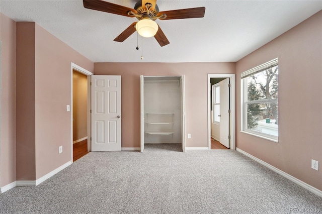 unfurnished bedroom with ensuite bath, light colored carpet, and ceiling fan