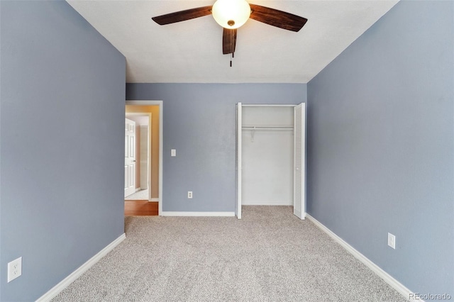 unfurnished bedroom featuring light carpet, a closet, and ceiling fan