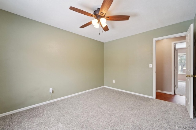 carpeted empty room featuring ceiling fan