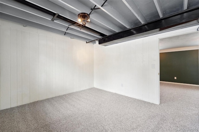 basement featuring wooden walls and carpet