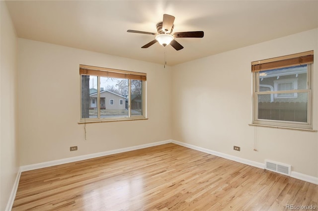 empty room featuring ceiling fan and light wood-type flooring