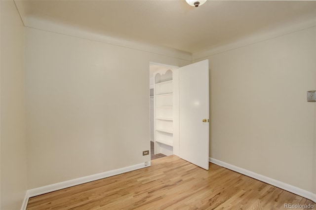 spare room with light wood-type flooring