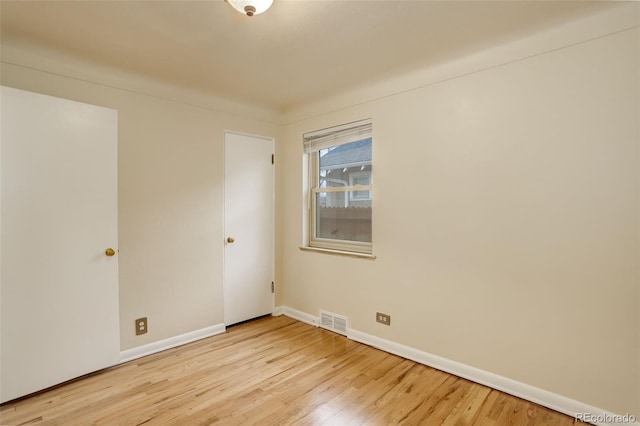 spare room with light hardwood / wood-style flooring