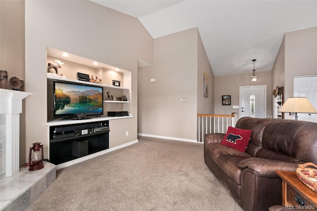 living area with high vaulted ceiling, carpet flooring, built in features, and baseboards