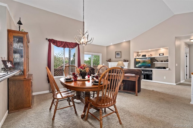 carpeted dining area with an inviting chandelier, baseboards, and high vaulted ceiling