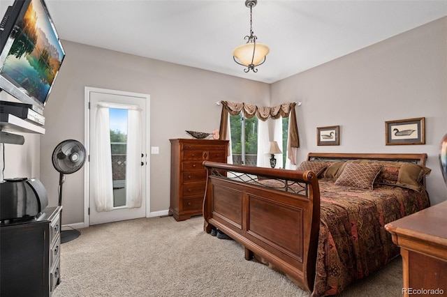 bedroom with carpet floors, access to outside, multiple windows, and baseboards